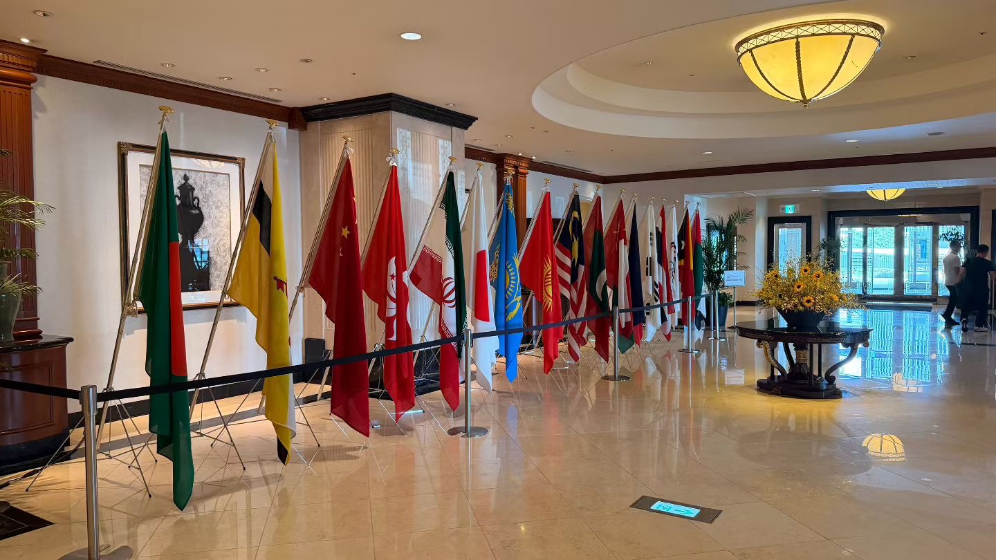International flags displayed in a hotel lobby during the Nagoya Asian Games programme